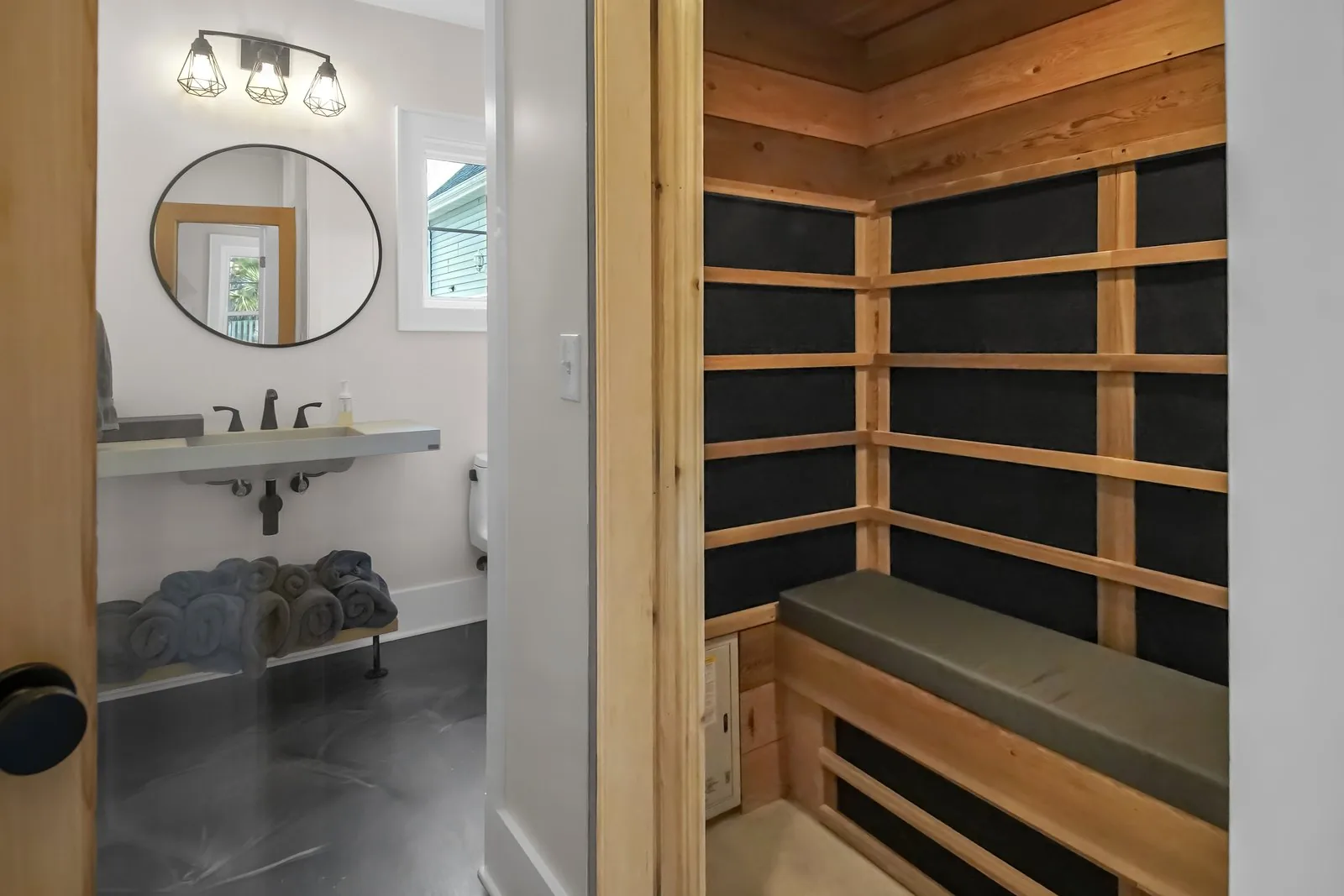 A cedar sauna and adjoining wet room with a stone vanity